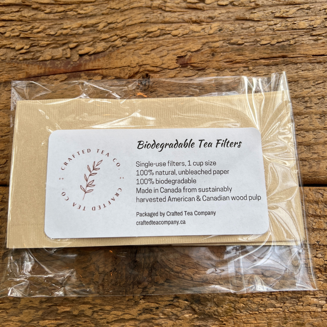 small package of biodegradable tea filters on a rustic wooden board